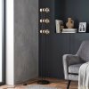 Staande lamp Voril met drie houten houders, zichtbare E27-fitting en voetschakelaar